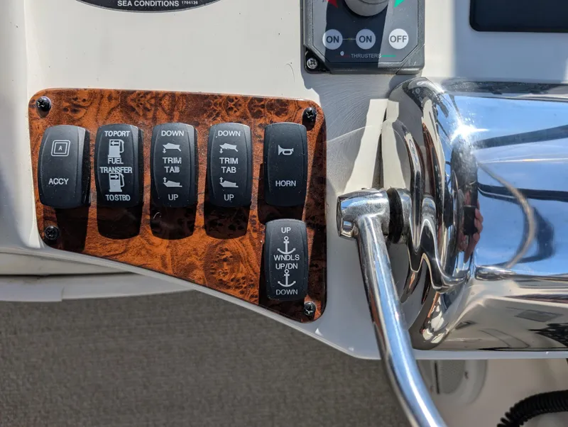 Slide: The Image of Control panel of a 2006 Meridian 368 boat with switches and throttle lever. - 23