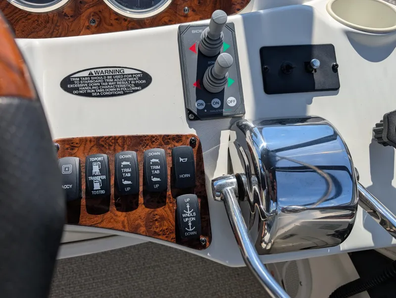 Slide: The Image of Control panel of a 2006 Meridian 368 boat with switches and throttle. - 24