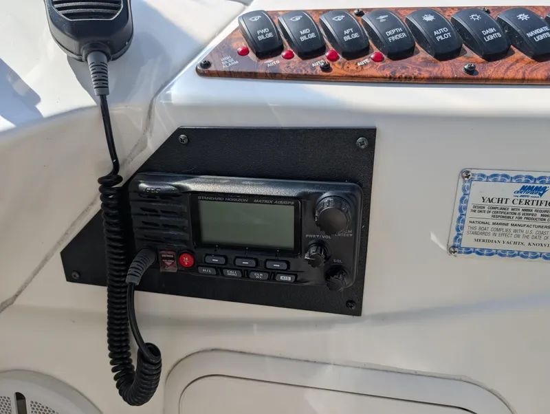 Slide: The Image of Control panel of a 2006 Meridian 368 yacht with radio and switches. - 25