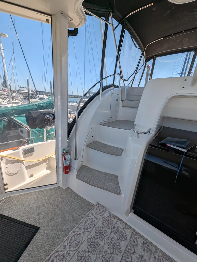 Slide: The Image of Interior view of a 2006 Meridian 368 yacht with stairs and marina background. - 4