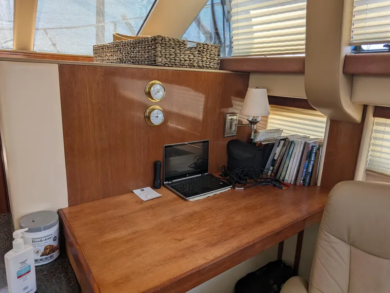 Slide: The Image of Interior of 2006 Meridian 368 yacht with desk, laptop, books, and decor. - 7