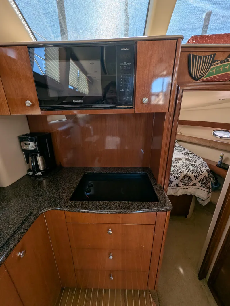 Slide: The Image of 2006 Meridian 368 yacht kitchen with microwave, coffee maker, and granite countertop. - 9