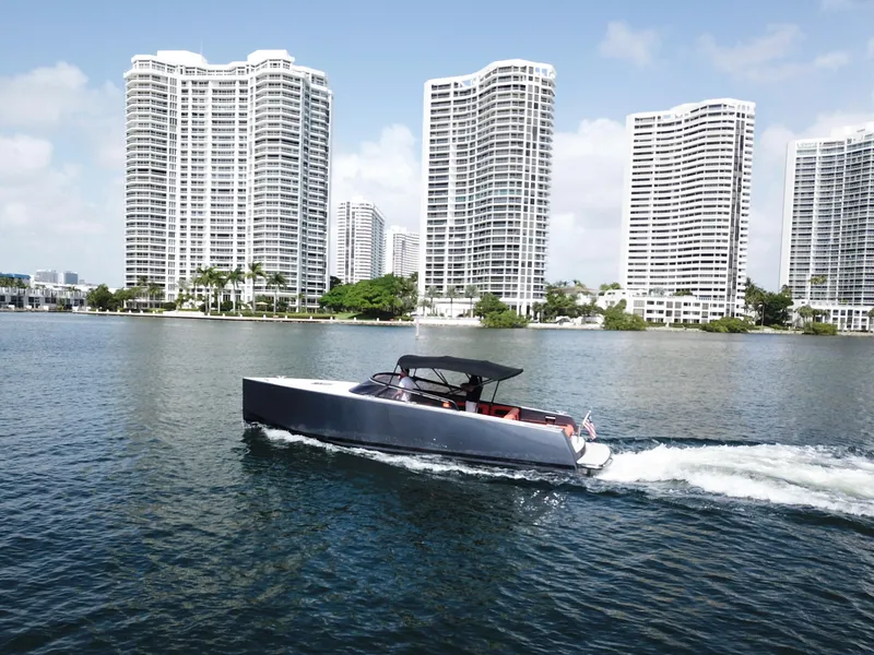 Slide: The Image of VanDutch 30 boat cruising near waterfront skyscrapers, 2016 model. - 1