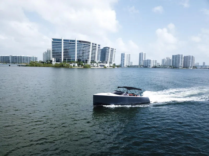 Slide: The Image of VanDutch 30 yacht cruising near modern city skyline, 2016 model. - 10
