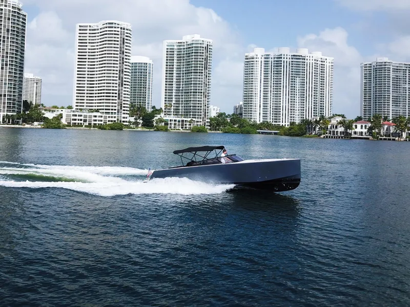 Slide: The Image of VanDutch 30 boat cruising near modern high-rise buildings, 2016 model. - 16
