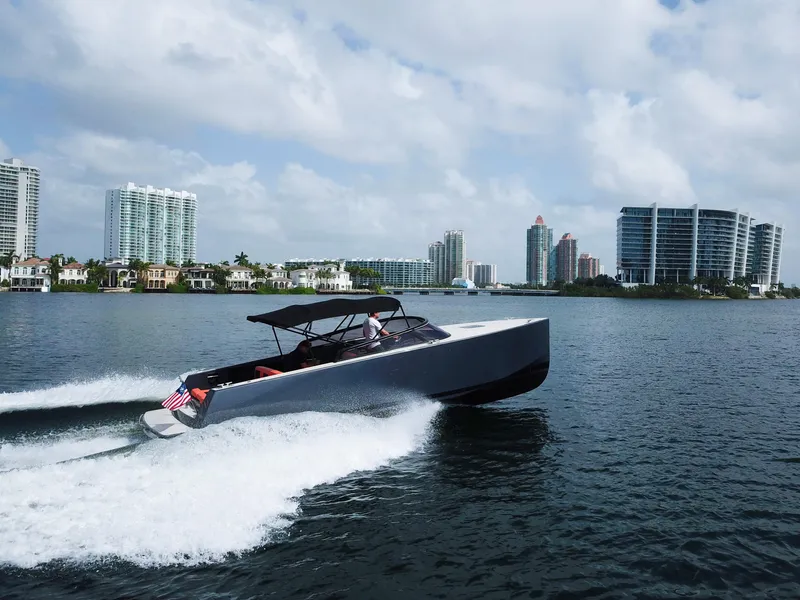 Slide: The Image of VanDutch 30 yacht cruising near modern waterfront cityscape, 2016 model. - 18