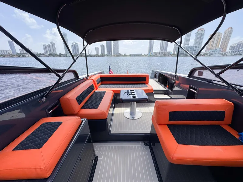 Slide: The Image of Luxurious 2016 VanDutch 30 yacht interior with orange seating, city skyline view. - 2