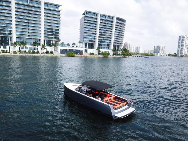 Slide: The Image of VanDutch 30 boat on water near modern high-rise buildings, 2016 model. - 22