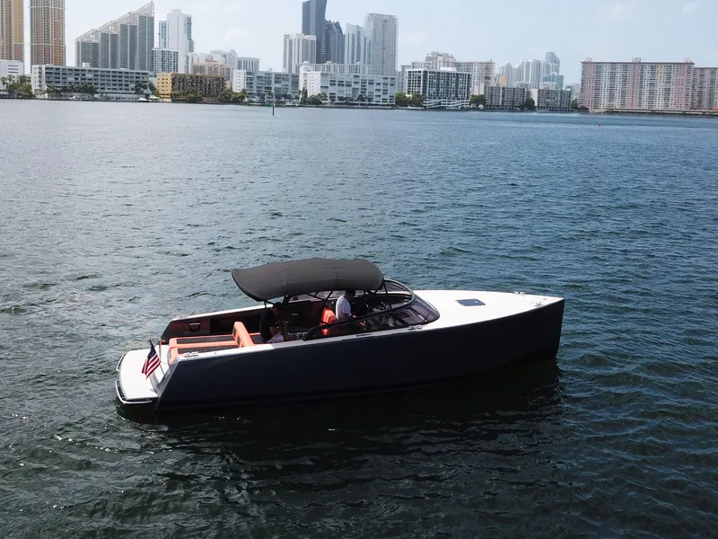 Slide: The Image of VanDutch 30 yacht cruising near city skyline, 2016 model, sleek design, calm waters. - 23