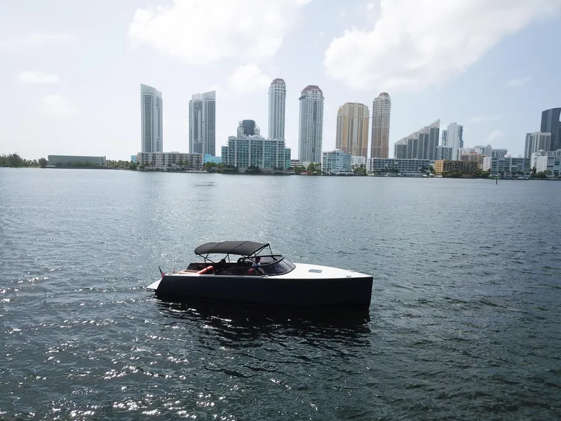 Slide: The Image of VanDutch 30 boat on water with city skyline in background, 2016 model. - 24