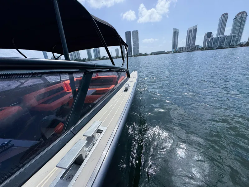 Slide: The Image of VanDutch 30 yacht cruising near city skyline, 2016 model, sunny day on the water. - 30