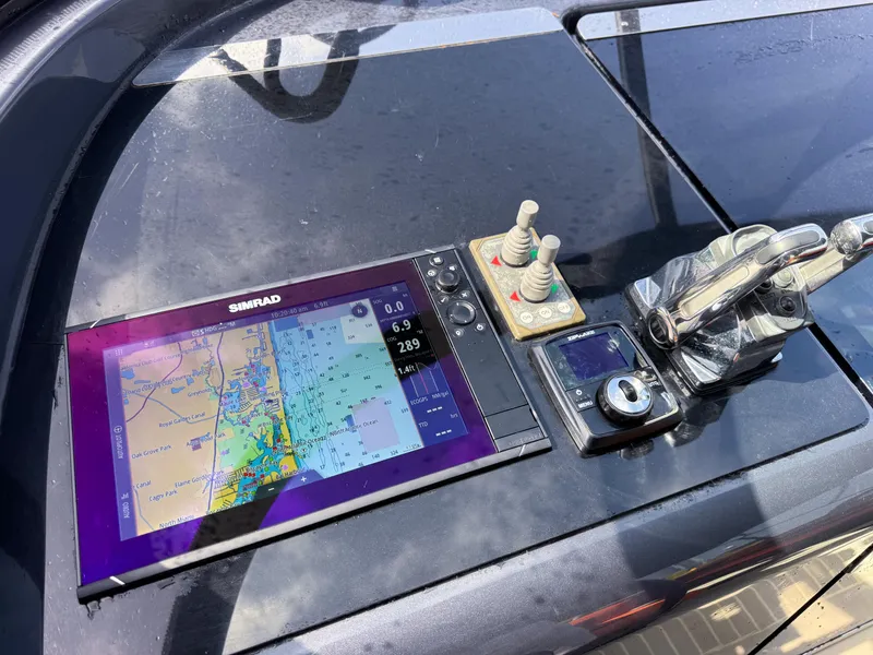 Slide: The Image of Control panel of a 2016 VanDutch 30 yacht with navigation display and controls. - 31