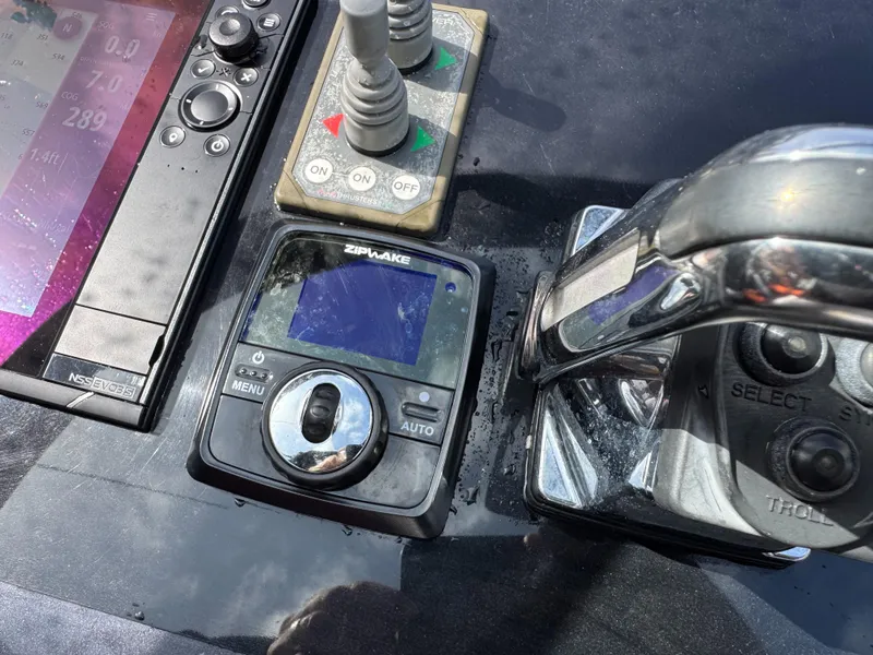 Slide: The Image of Control panel of a 2016 VanDutch 30 boat with navigation and throttle controls. - 32