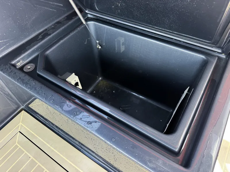Slide: The Image of Open storage compartment on a 2016 VanDutch 30 boat, showing interior details. - 34
