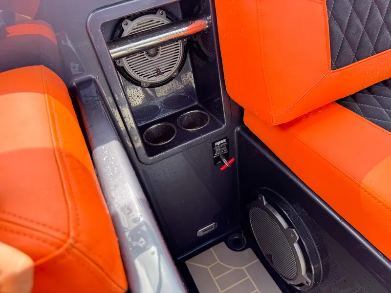 Slide: The Image of Interior of 2016 VanDutch 30 boat with orange seating and speaker system. - 35