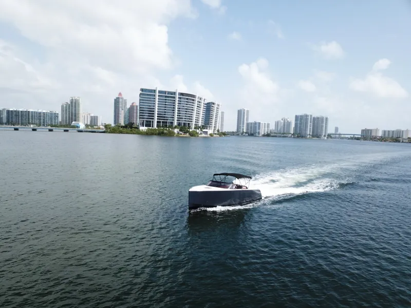 Slide: The Image of VanDutch 30 yacht cruising near modern city skyline, 2016 model. - 8