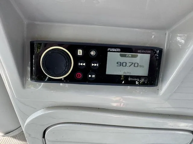 Slide: The Image of Radio control panel on 2017 Crest Caribbean 250 L boat, displaying FM 90.70 Hz. - 9