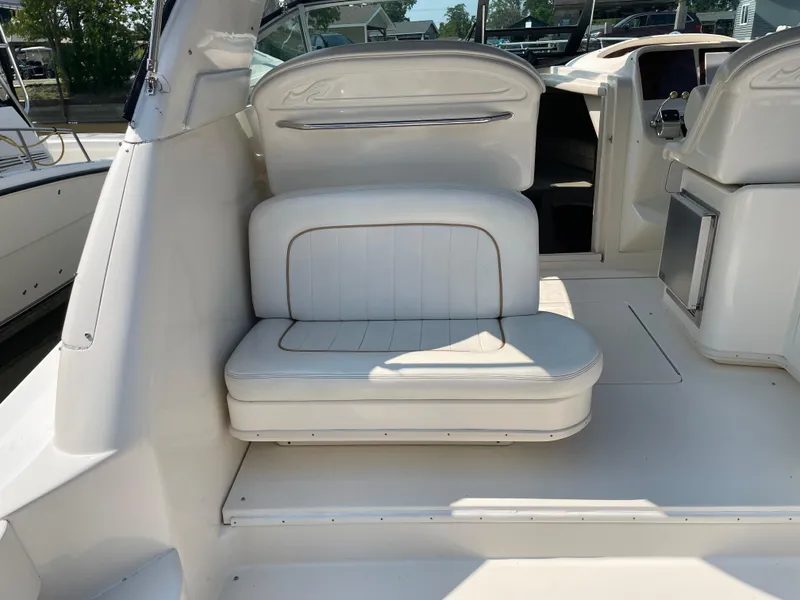 Slide: The Image of 1997 Sea Ray 330 Express boat interior with white seating and sleek design. - 11
