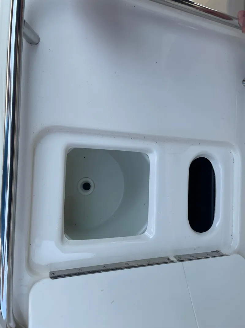 Slide: The Image of 1997 Sea Ray 330 Express boat sink and storage compartment. - 14