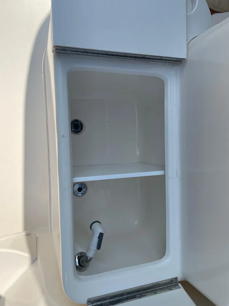 Slide: The Image of Open storage compartment on a 1997 Sea Ray 330 Express boat. - 15