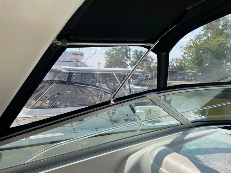 Slide: The Image of 1997 Sea Ray 330 Express boat interior view with marina background. - 16