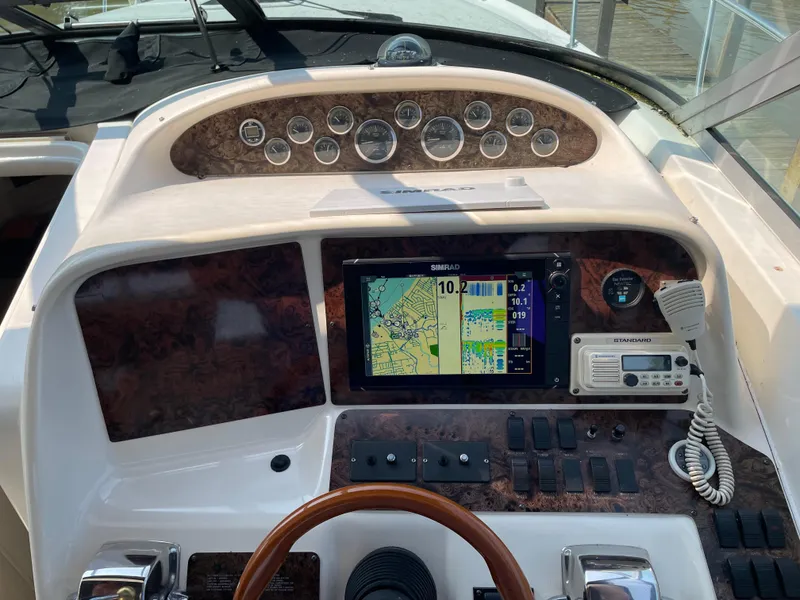 Slide: The Image of 1997 Sea Ray 330 Express dashboard with navigation system and controls. - 20