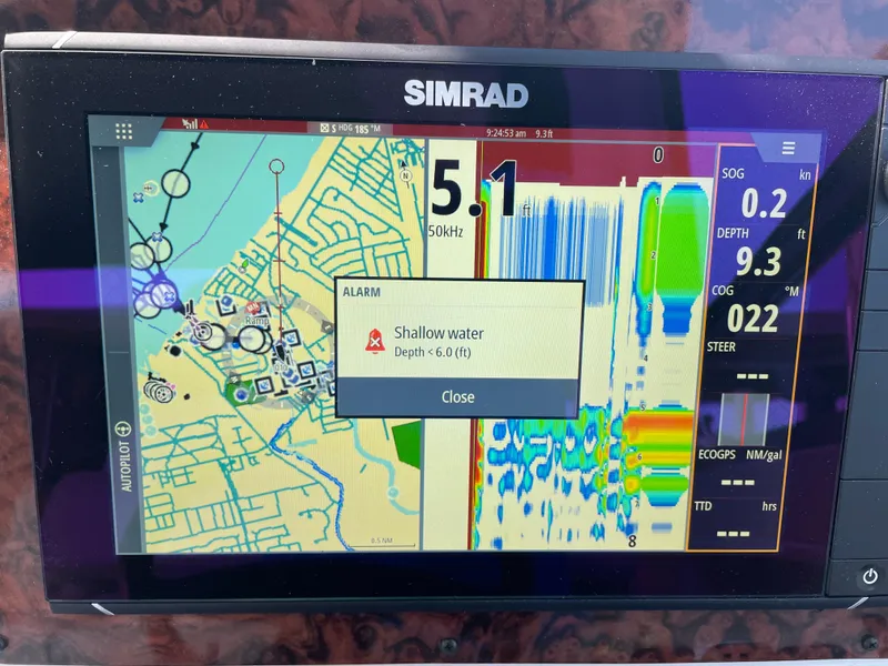 Slide: The Image of Simrad marine GPS displaying shallow water alert on Sea Ray 330 Express, 1997 model. - 22
