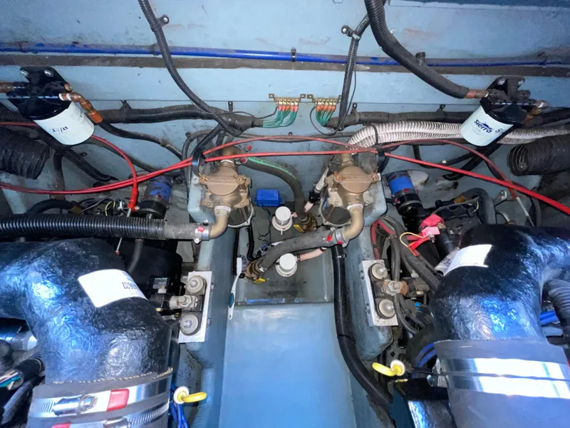 Slide: The Image of Engine compartment of a 1997 Sea Ray 330 Express boat, showcasing wiring and components. - 23