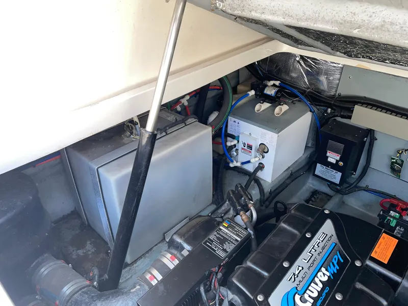 Slide: The Image of Engine compartment of a 1997 Sea Ray 330 Express boat, featuring mechanical components and wiring. - 29