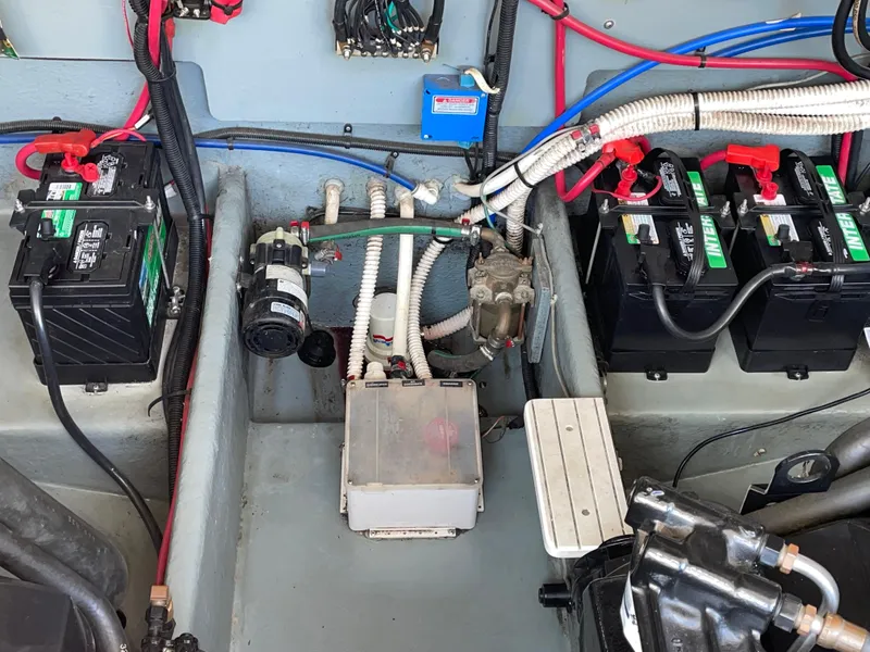 Slide: The Image of Engine compartment of a 1997 Sea Ray 330 Express with batteries and wiring. - 30