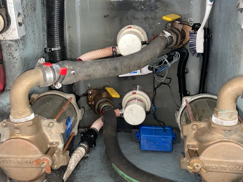 Slide: The Image of Engine compartment of a 1997 Sea Ray 330 Express with visible pumps and hoses. - 31