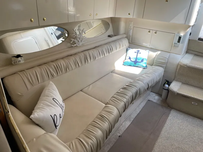 Slide: The Image of Luxurious interior of 1997 Sea Ray 330 Express yacht with plush seating and nautical decor. - 32