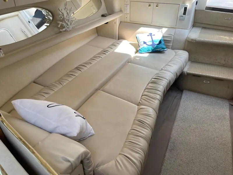 Slide: The Image of Interior of 1997 Sea Ray 330 Express with beige seating and nautical decor. - 36