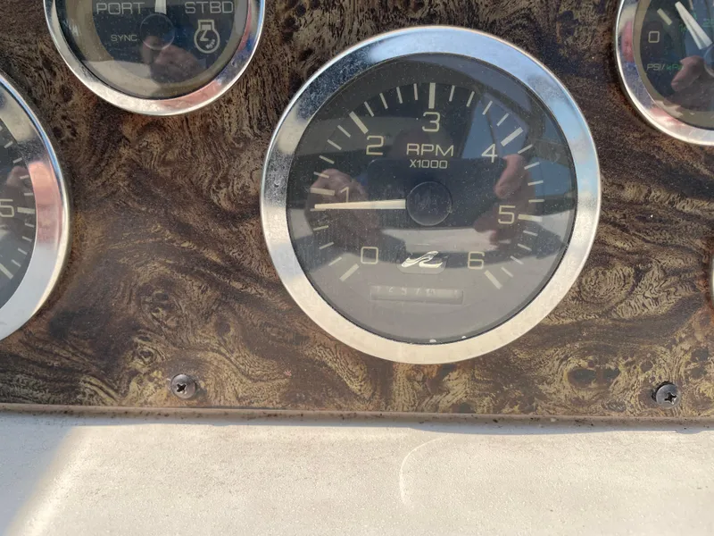 Slide: The Image of 1997 Sea Ray 330 Express dashboard with RPM gauge and wood grain panel. - 40