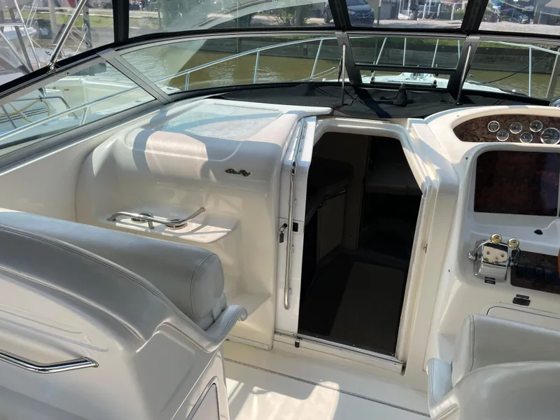 Slide: The Image of 1997 Sea Ray 330 Express boat interior with helm and cabin entrance. - 7