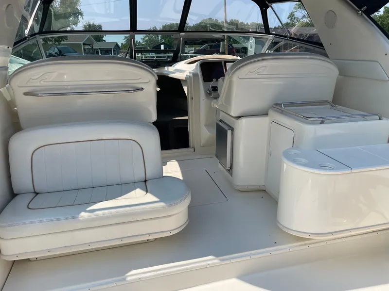 Slide: The Image of 1997 Sea Ray 330 Express boat interior with white seating and helm station. - 8
