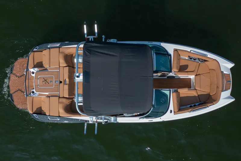 Slide: The Image of Aerial view of 2021 MasterCraft X22 boat with tan seating and black canopy. - 10