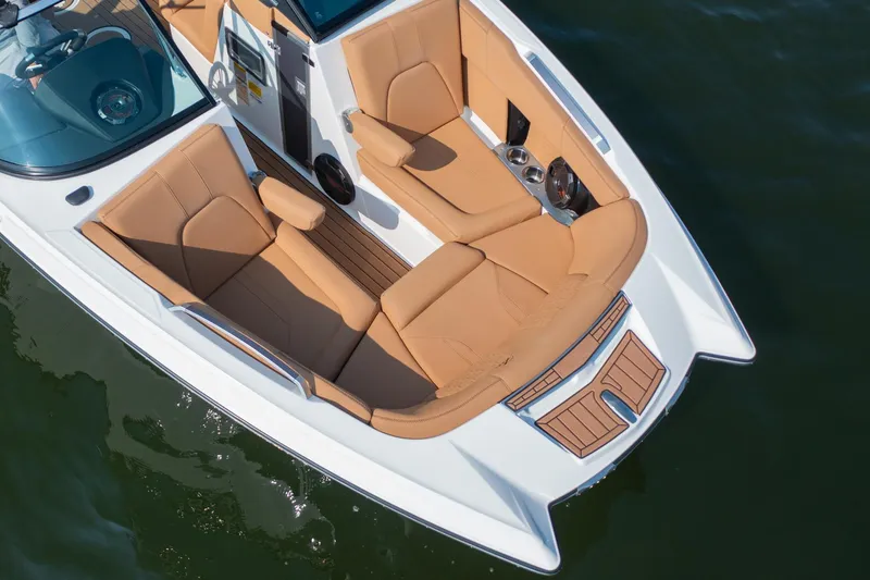Slide: The Image of Luxurious seating on 2021 MasterCraft X22 boat, featuring tan upholstery and sleek design. - 11