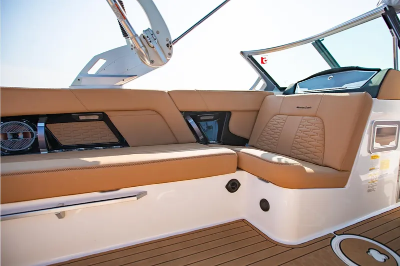 Slide: The Image of 2021 MasterCraft X22 boat interior with tan seating and modern design elements. - 19