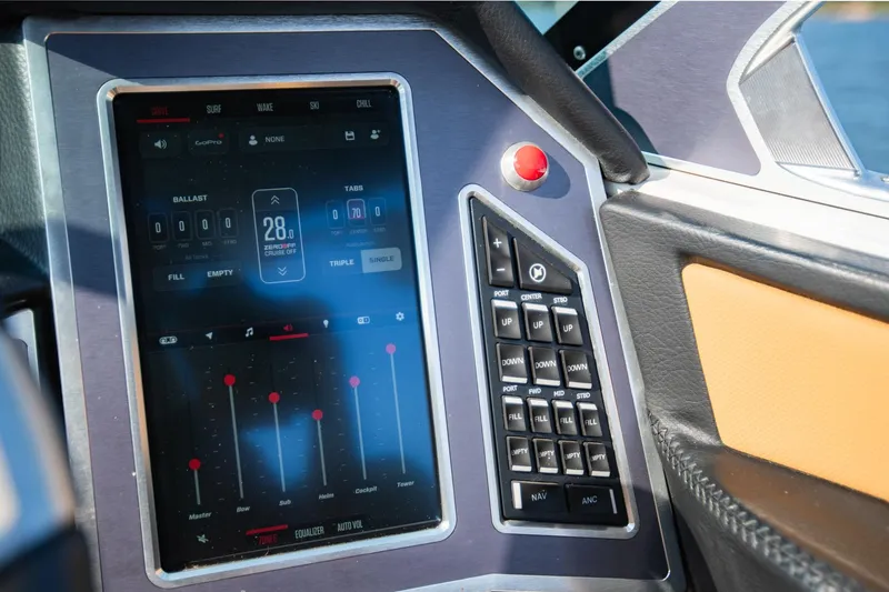 Slide: The Image of 2021 MasterCraft X22 boat dashboard with touchscreen controls and buttons. - 23