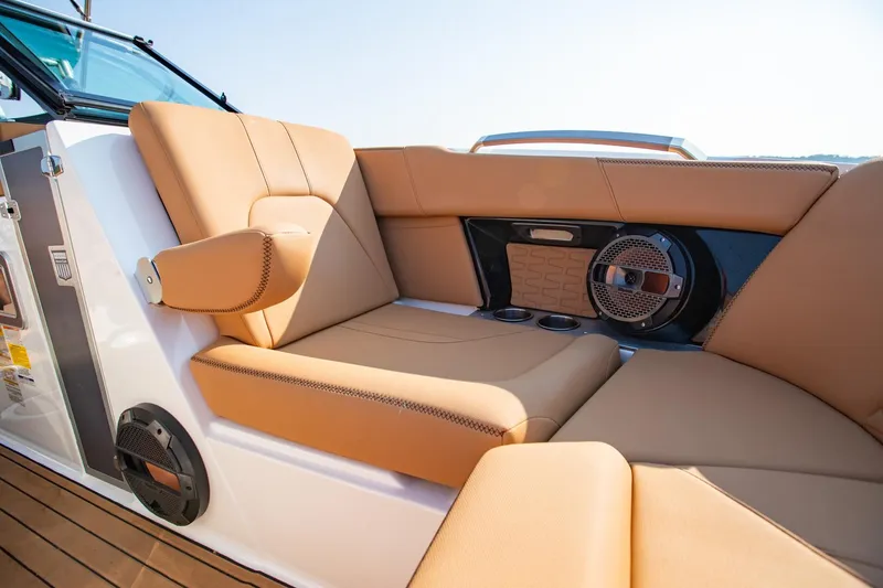Slide: The Image of 2021 MasterCraft X22 boat interior with tan leather seating and built-in speaker system. - 31