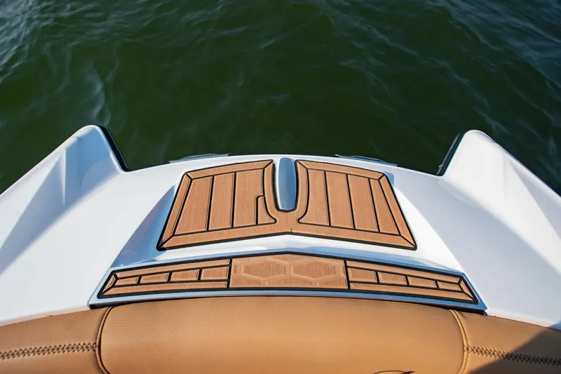 Slide: The Image of 2021 MasterCraft X22 boat swim platform with teak decking on calm water. - 33