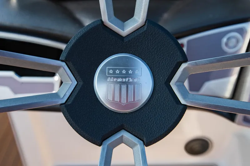 Slide: The Image of Steering wheel of 2021 MasterCraft X22 boat with logo detail. - 39