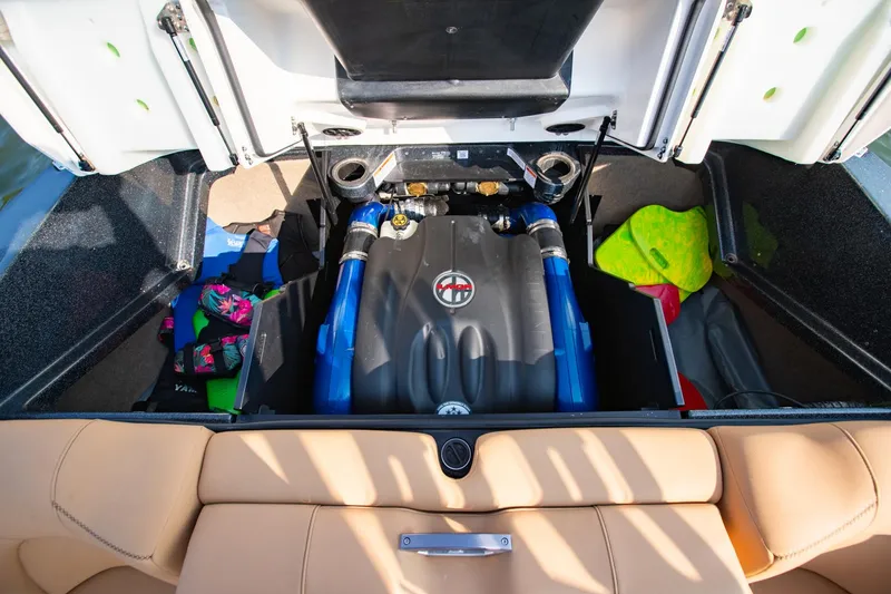 Slide: The Image of 2021 MasterCraft X22 engine compartment with colorful life jackets and accessories. - 47