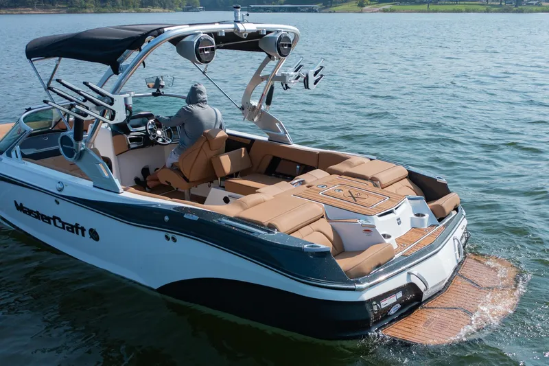Slide: The Image of 2021 MasterCraft X22 boat on water, featuring luxurious seating and advanced controls. - 7