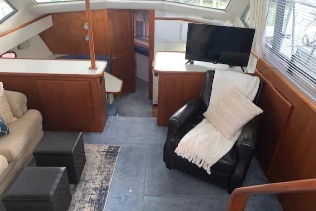 Slide: The Image of Interior of 1995 Carver 370 Aft Cabin with cozy seating and modern decor. - 14