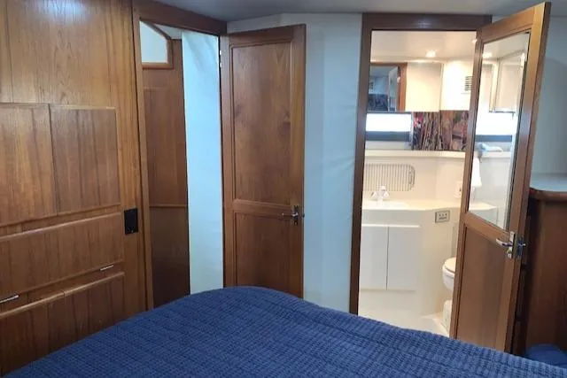 Slide: The Image of Interior of 1995 Carver 370 Aft Cabin with wooden doors and cozy bedroom. - 21
