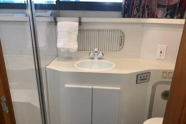 Slide: The Image of 1995 Carver 370 Aft Cabin bathroom with sink, towel rack, and modern fixtures. - 22