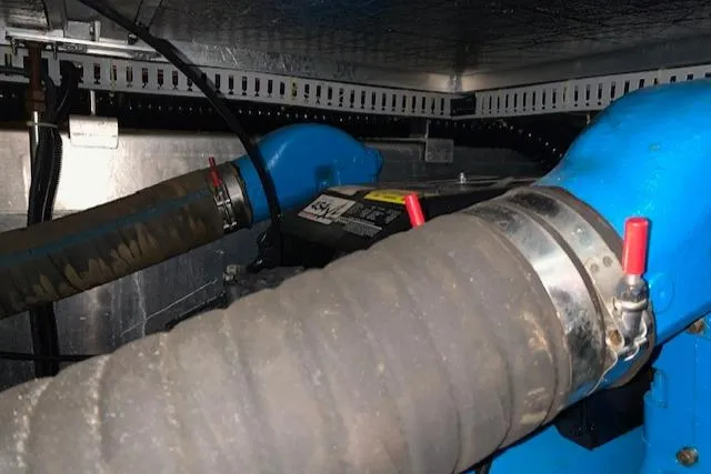 Slide: The Image of Engine compartment of a 1995 Carver 370 Aft Cabin with visible hoses and clamps. - 24