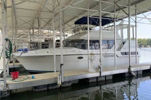 Slide: The Image of 1995 Carver 370 Aft Cabin yacht docked in a covered marina. - 7